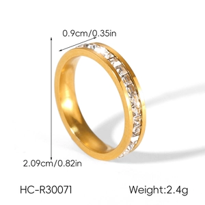 Detail view of a 0.9cm wide gold stainless steel ring with square zircon stones