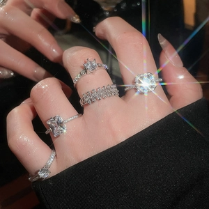 Close-up of five-piece zircon heart ring set showing brilliant sparkle on hand