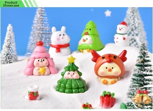 Close-up of resin mini Christmas animal figurines in cute outfits on faux snow