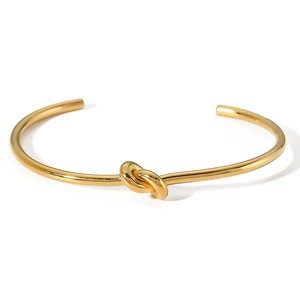 Polished 18K gold plated stainless steel open bangle featuring a minimalist knot design