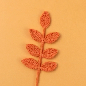 Handmade orange crochet stem with seven leaves for seasonal bouquets and floral decor