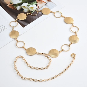 Detail of adjustable gold metal waist chain with textured round discs and lobster clasp