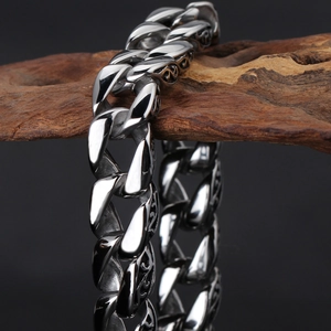 Macro shot of retro silver stainless steel cuban chain with detailed side engravings
