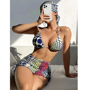 Three-piece bikini set with drawstring skirt and matching headscarf in vibrant geometric pattern