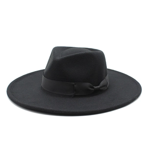 Close-up of black wool felt fedora featuring a matching grosgrain ribbon and bow detail