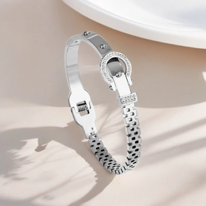 Detailed close-up of a silver titanium steel bracelet with pavé-set zircons and chain link