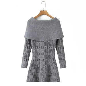 Detail of grey cable knit dress showing thick texture and off-shoulder neckline