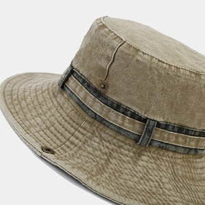 Detail of vintage washed denim hat featuring rustic stitching and metal buckle accents