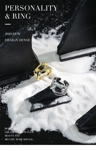 Close-up of minimalist silver and gold chain rings displayed on textured stones