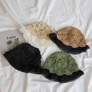Flat lay of handmade crochet straw hats with chiffon ruffles in four soft colors
