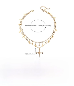 Detailed view of rhinestone-encrusted gold cross necklace with dimension and material specs