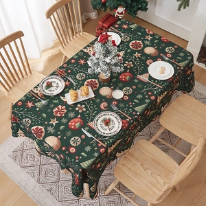 Detail of dark green Christmas tablecloth with snowflakes and holiday tree patterns