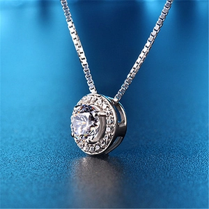 Macro shot of 2 carat halo necklace with a round sparkling zircon stone and box chain