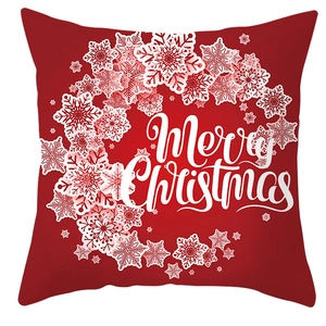 Detail of red Christmas pillowcase featuring a white snowflake wreath and Merry Christmas text