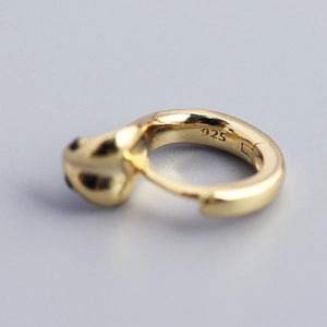 Detailed close-up of 925 sterling silver gold-plated cobra hoop earring with hallmark