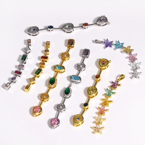 Macro detail of colorful zircon flower and teardrop pendants in gold and silver finish
