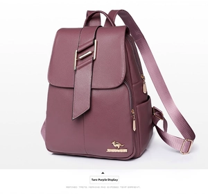 Macro detail of purple faux leather backpack featuring metallic logo and lychee grain texture