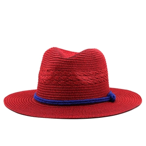 Classic red straw Panama hat with wide brim and decorative navy blue rope band