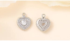 Detail of silver heart pendants with cubic zirconia showing front and back texture