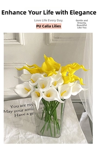Detail of yellow and white PU calla lily bouquet in a glass vase for home decor