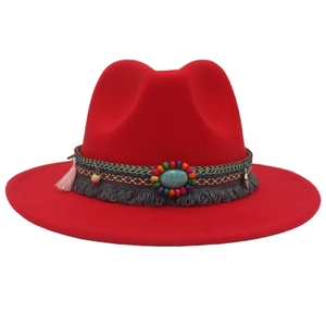 Detailed close-up of ethnic beaded band with turquoise on a red wool felt cowboy hat