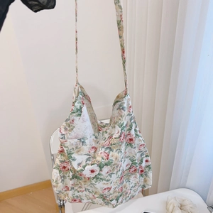 Close-up of vintage floral cotton tote bag with pink roses and long shoulder strap