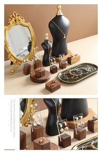 Detail of luxury jewelry display stand with walnut wood base and acrylic earring boards