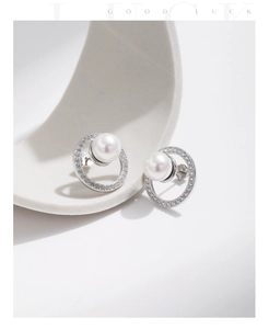 Close-up of S925 silver round stud earrings featuring white pearl and pavé crystals