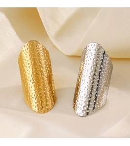 Detailed close-up of gold and silver wide hammered texture stainless steel armor rings