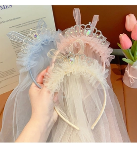 Detail of glittery princess tiara headband with tulle veil in blue pink and beige