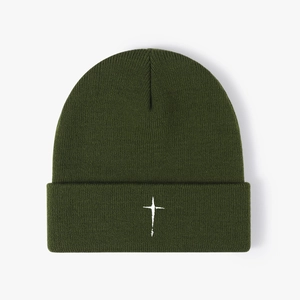 Minimalist dark green knit beanie with white embroidered cross on a plain white background