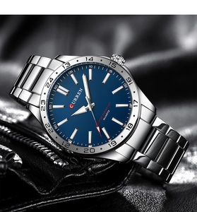 Detailed close-up of CURREN men's watch with blue dial and silver steel band on leather