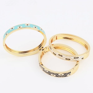 Three gold-plated Evil Eye cuff bracelets with blue, white and black enamel detailing