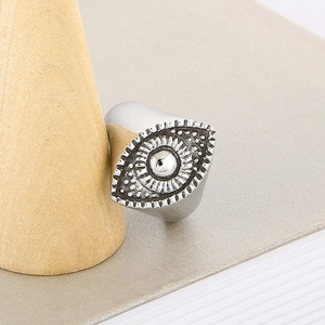 Gothic silver stainless steel evil eye sunburst ring for men shown on wood stand