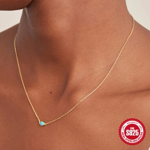 Elegant S925 sterling silver necklace with oval turquoise pendant worn by a model