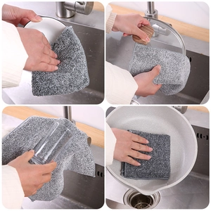 Thick bamboo charcoal dishcloth cleaning grease from bowls and pans in a kitchen