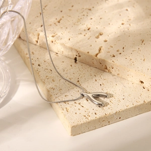 Elegant stainless steel starfish necklace with a Y-shape pendant on natural stone base