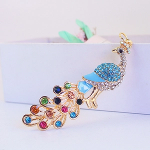 Colorful rhinestone peacock keychain in gold plating with blue enamel details for women