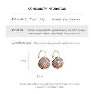 Macro shot of rhinestone studded round sphere earrings with detailed size and weight specs