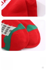 Close-up of neatly stitched toes on cotton festive crew socks with red and green patterns