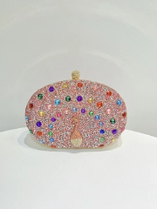Detailed macro of pink rhinestone peacock clutch bag with vibrant crystal embellishments