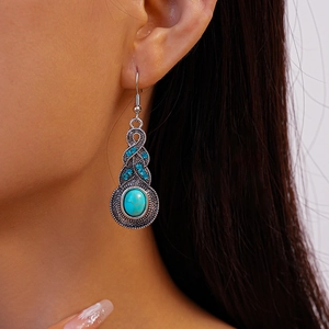 Vintage silver drop earring with turquoise stone and blue rhinestones on a model