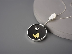 Detailed close-up of S925 sterling silver butterfly pendant with mother of pearl inlay