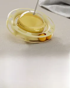 Close-up of yellow four-in-one cat toy with multi-layer orbital tracks and a spring wand