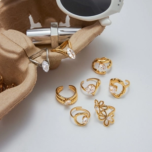 Set of seven titanium steel rings with cubic zirconia in assorted gold and silver finishes