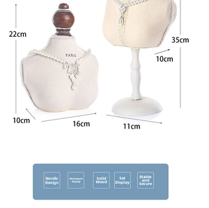 Portrait bust necklace display stands in beige fabric with dark wood base in two heights