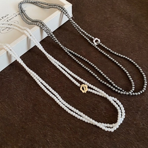 Elegant multi-layer pearl necklace with vintage floral clasp in white and dark gray