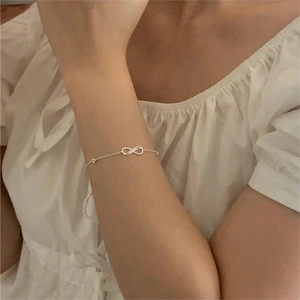 Detailed close-up of a sterling silver infinity symbol bracelet with pavé cubic zirconia