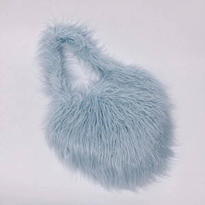 Detail shot of heart-shaped fluffy faux fur shoulder bag in light blue soft material