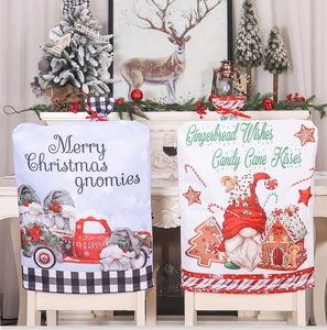 Close-up of Christmas chair covers with gnome and gingerbread house patterns on fabric